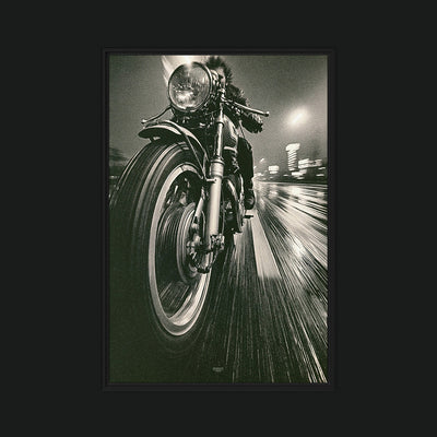 Grip framed artwork view: a low-angle monochrome motorcycle front wheel and headlamp against a blurred night street.