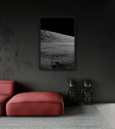 I. Approach room mockup: a monochrome lunar slope descending from left to right beneath a black sky, shown above a red chaise.