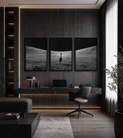 Into the Silence Collection room mockup: three monochrome lunar landscapes with a solitary astronaut in the center panel, shown above an office desk.