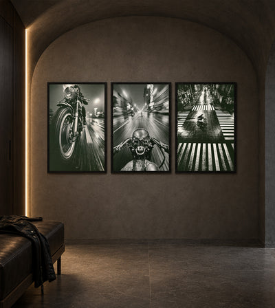 Built to Vanish Collection room mockup: three monochrome motorcycle artworks showing a front wheel, rider-view cockpit and overhead street crossing, shown on an arched bedroom wall.