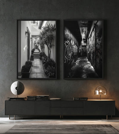 One And The Same Bundle room mockup: two monochrome passage artworks contrasting a graffiti alley and a bright plant-lined courtyard, shown above a low cabinet.
