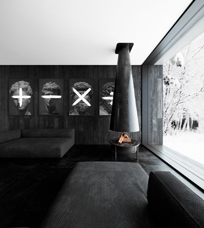 One And Only Truth Collection room mockup: four monochrome classical heads marked with plus, minus, multiplication and division signs, shown beside a suspended fireplace in a living room.