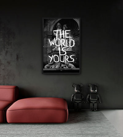 The World Is Yours room mockup: white THE WORLD IS YOURS lettering over black-and-white classical statues, shown above a red chaise.