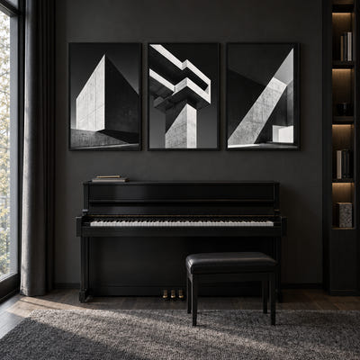 Against the Light Collection: three monochrome concrete architecture studies with sharp light and shadow, displayed in an interior.