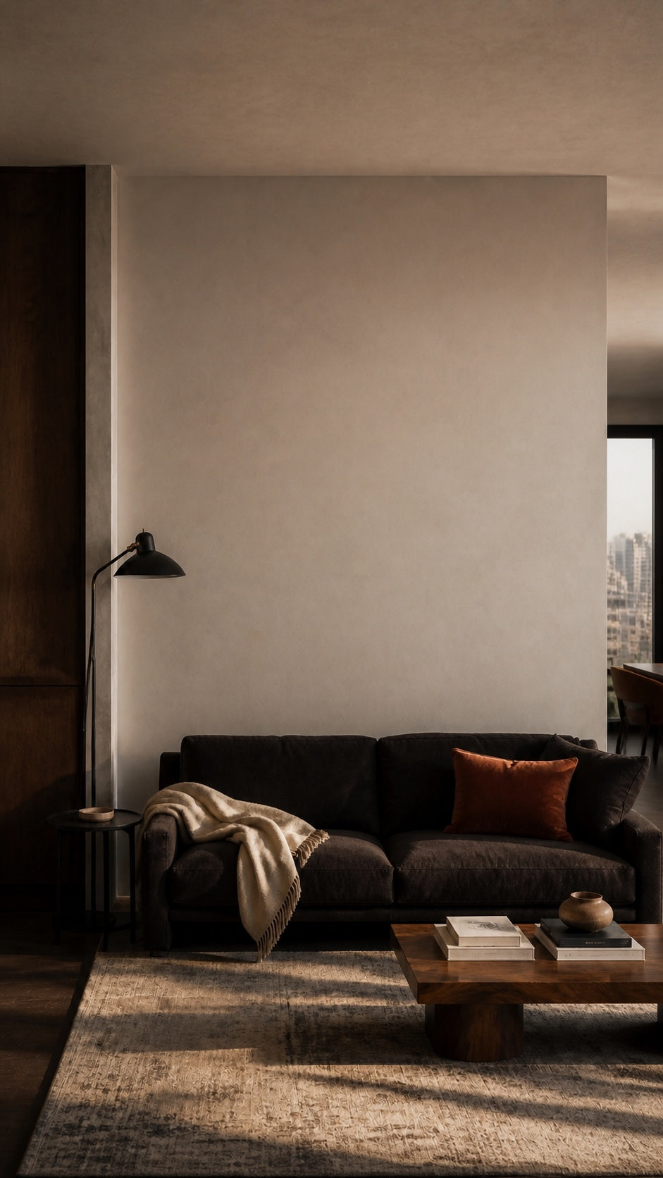 A thoughtfully furnished living room with one large blank wall still unresolved